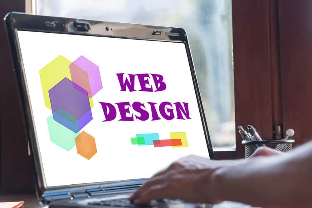 A laptop screen displaying web design text