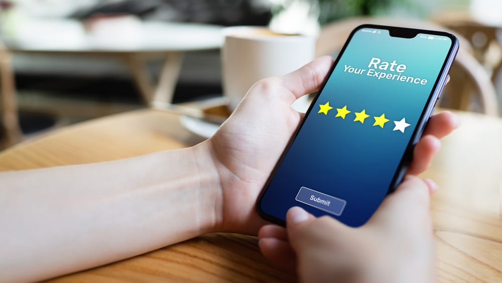 Rate your experience customer satisfaction review Five Stars on mobile phone screen. Business technology concept