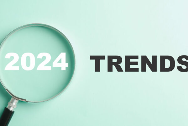 The image features magnifier glasses with the text New Year 2024 Trends, emphasizing the main trend of change. It represents the evaluation methods, popular topics, and new trends in business.