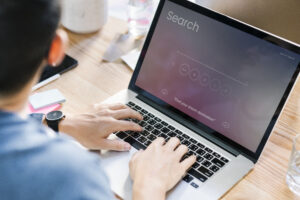 A man using laptop to search for information