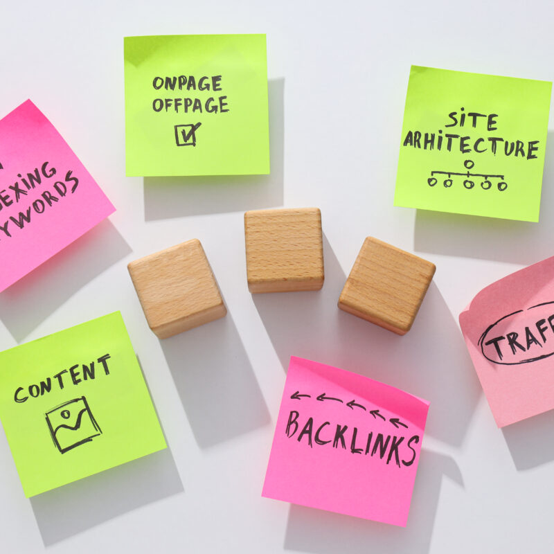 Notes and three wooden cubes on white background, top view