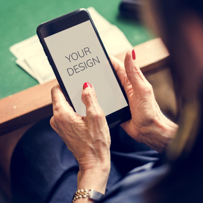 Hands holding smartphone with a word your design on a screen