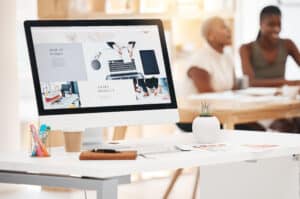 Graphic design, website and marketing with an advertising campaign on the screen of a computer in a.