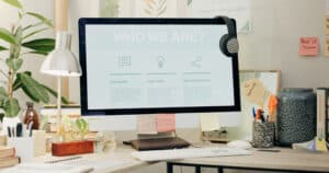 Office, computer screen and website about us, information on crm business for virtual assistant. Mo.