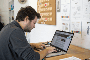 a-man-using-his-computer-creating-web-design (1)