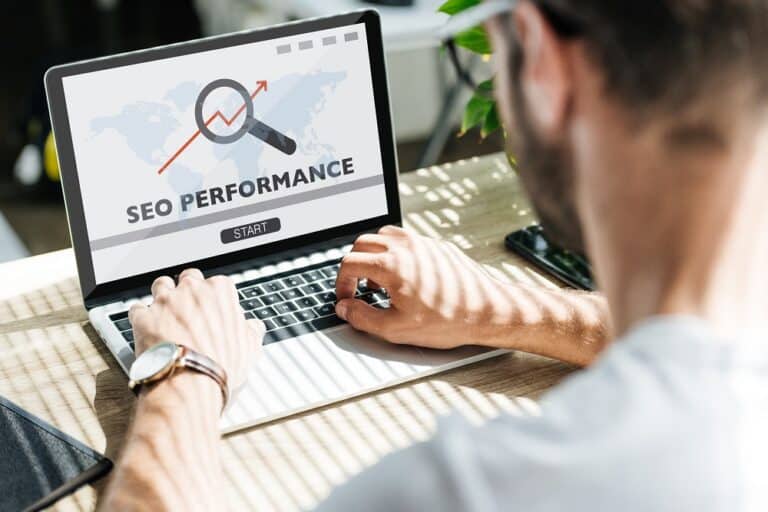 Person typing on a laptop that shows an SEO performance screen