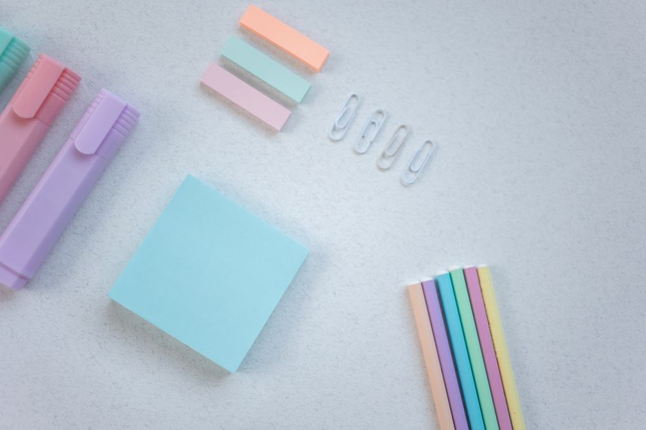 Color coded sticky notes, clips and highlighters, representing the four separate types of SEO