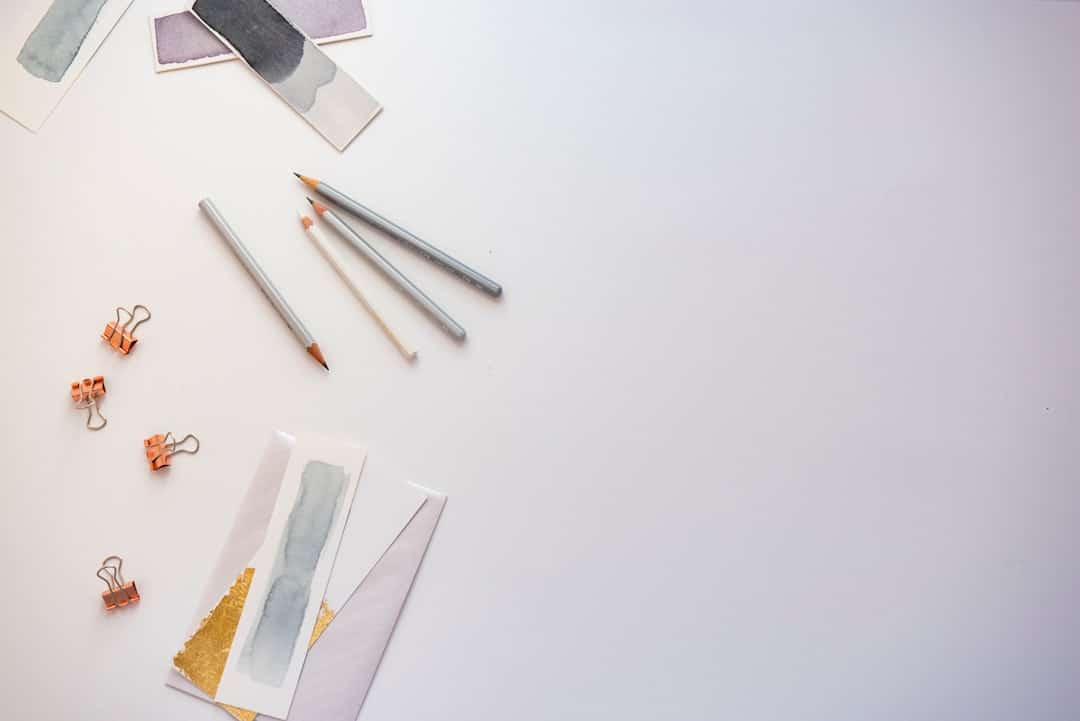 Pencils and copper paper clips arranged on white, representing a technical SEO checklist