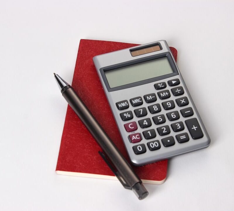 Calculator and pen resting on a notebook, representing how a San Antonio business budgets for monthly SEO