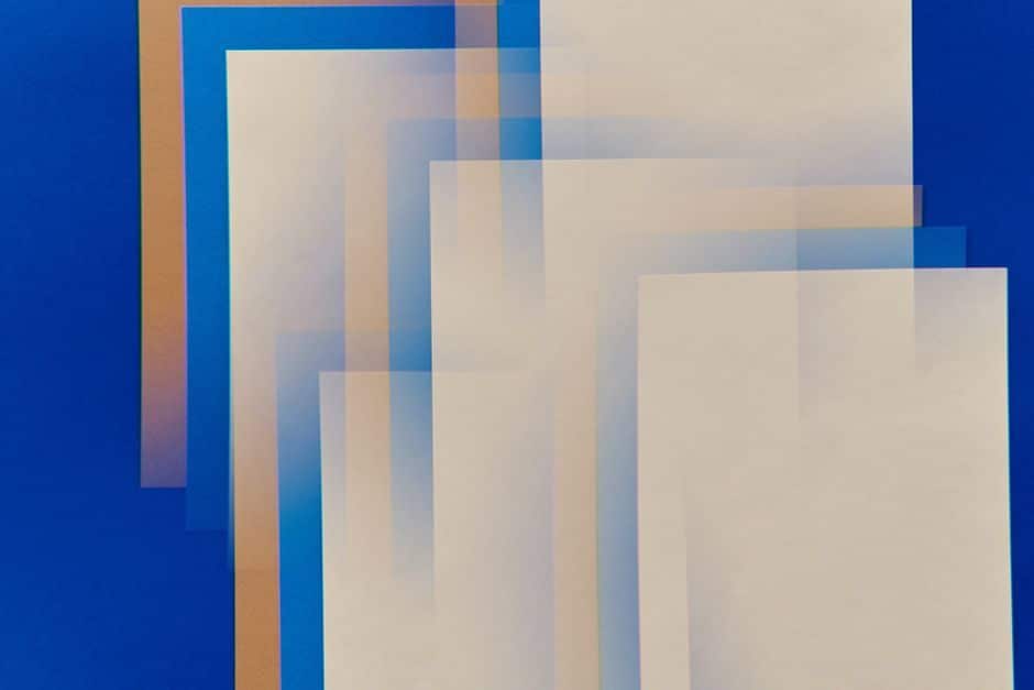 Translucent sheets stacked in layers over a blue background