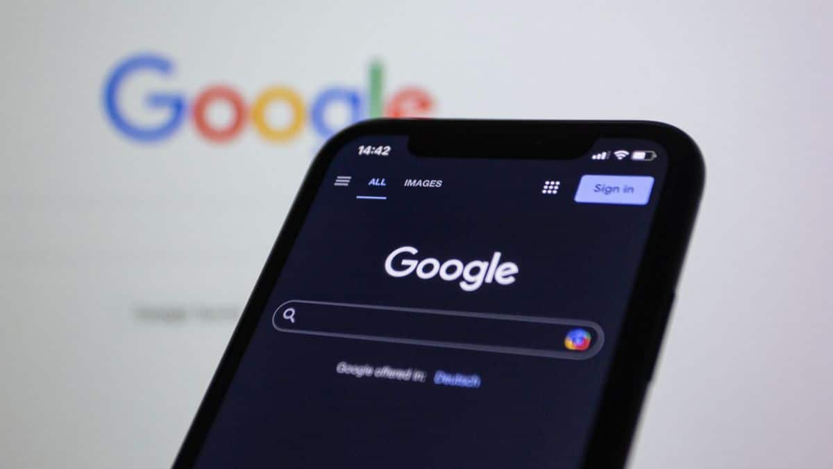 Smartphone showing the Google search page, with the Google logo blurred in the background